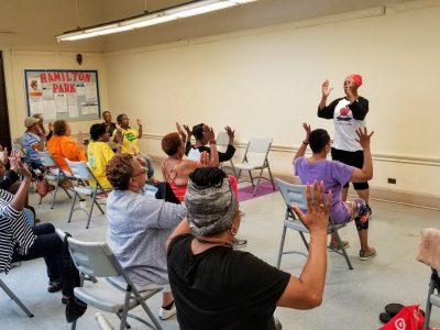 Darlene Blackburn, YogaCare Alumna of our Scholarship Program teaching Chair Yoga at the Englewood Community Wellness Retreat in collaboration with Howard Brown Health and Northwestern University's ARCC Seed Grant project in the summer of 2019