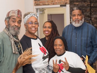 YogaCare Scholarship Alumni and friends at YogaCare's Anniversary Party fundraiser in Washington Park in 2017 - MUNTU Dance Theater founding member Baba Eli Hoenai, YogaCare Alumni Darlene Blackburn ('16), Ayoka Mitchell ('17), Calvin Fortenberry ('17),