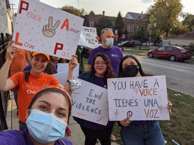 Esperanza Health Center Staff holding signs "Peace, Love - Amor, Paz", "You have a voice - Tienes una voz"